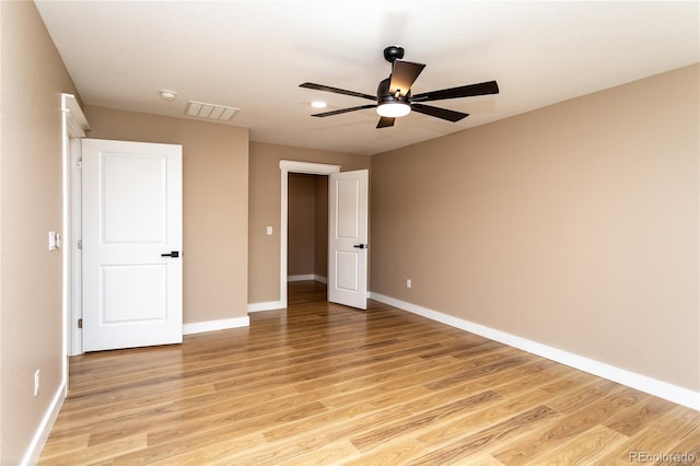 empty room featuring ceiling fan and light hardwood / wood-style floors