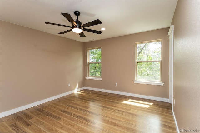 spare room featuring ceiling fan, plenty of natural light, and light hardwood / wood-style floors