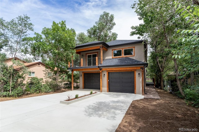 view of front of property featuring a balcony and a garage