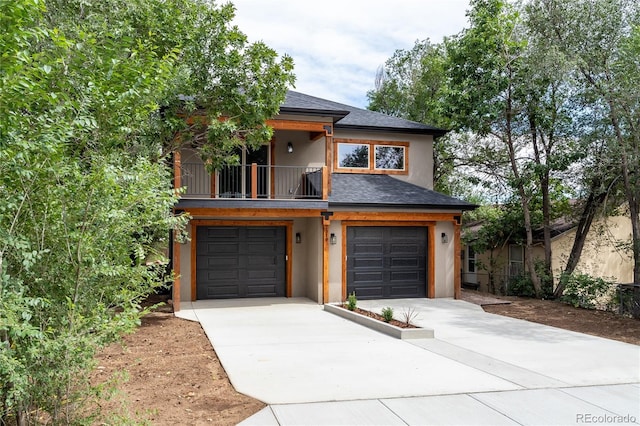 view of front of home with a garage and a balcony