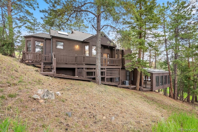 23599 Shingle Creek Rd, Golden, CO 80401 - back of property with a sunroom, a deck, and roof with shingles