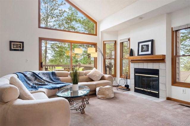 23599 Shingle Creek Rd, Golden, CO 80401 - carpeted living room featuring a tiled fireplace and high vaulted ceiling