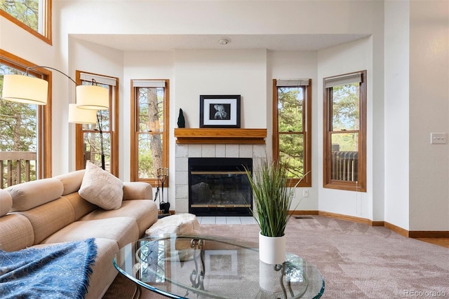23599 Shingle Creek Rd, Golden, CO 80401 - carpeted living area featuring baseboards and a tiled fireplace