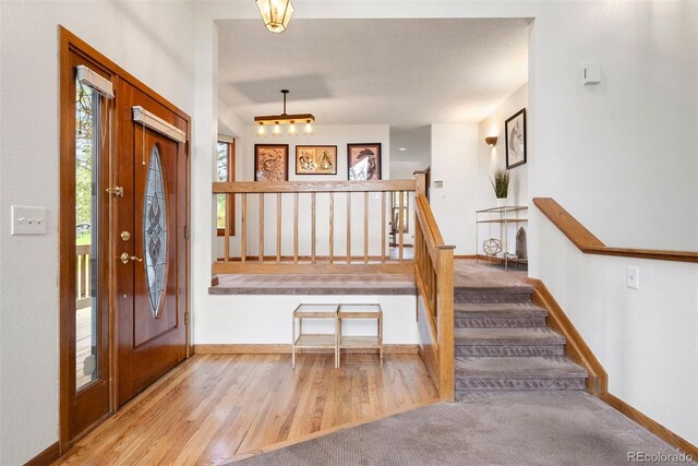 23599 Shingle Creek Rd, Golden, CO 80401 - entrance foyer with stairs and wood finished floors
