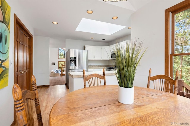 23599 Shingle Creek Rd, Golden, CO 80401 - dining space with a skylight, recessed lighting, plenty of natural light, and light wood-type flooring