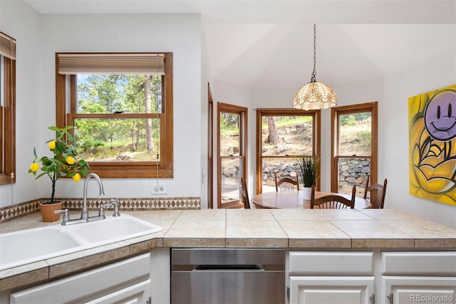 23599 Shingle Creek Rd, Golden, CO 80401 - kitchen featuring dishwasher, tile countertops, white cabinets, decorative light fixtures, and a peninsula