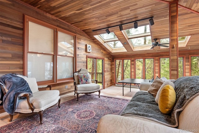 23599 Shingle Creek Rd, Golden, CO 80401 - living area with a skylight, wooden walls, wooden ceiling, vaulted ceiling, and baseboard heating