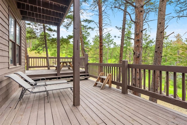 23599 Shingle Creek Rd, Golden, CO 80401 - wooden terrace featuring view of wooded area