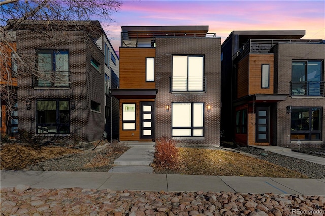 modern home featuring brick siding