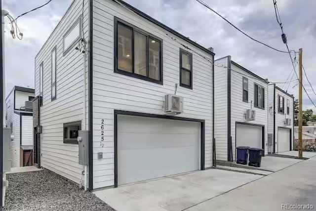 2625 W 23rd Ave, Denver, CO 80211 - view of property exterior featuring an AC wall unit, a garage, and driveway