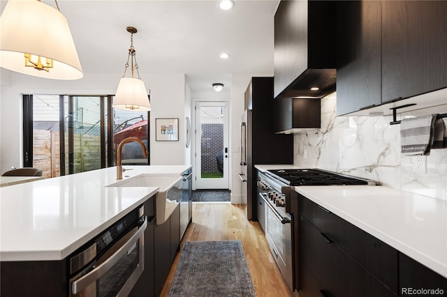 2625 W 23rd Ave, Denver, CO 80211 - kitchen with light wood finished floors, a sink, high quality appliances, backsplash, and light countertops