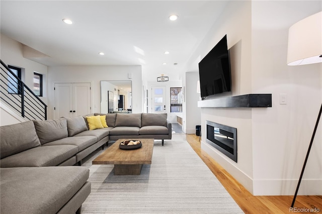 2625 W 23rd Ave, Denver, CO 80211 - living area featuring recessed lighting, stairway, light wood-style flooring, baseboards, and a glass covered fireplace