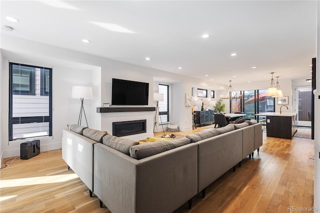 2625 W 23rd Ave, Denver, CO 80211 - living room featuring recessed lighting, light wood-style flooring, baseboards, and a glass covered fireplace