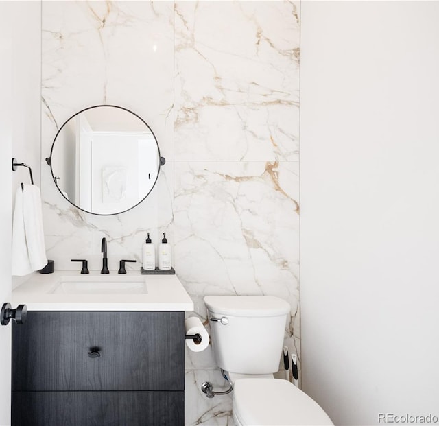 2625 W 23rd Ave, Denver, CO 80211 - bathroom featuring toilet, tile walls, and vanity