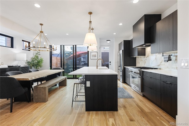 2625 W 23rd Ave, Denver, CO 80211 - kitchen featuring high end appliances, light countertops, dark cabinetry, and modern cabinets