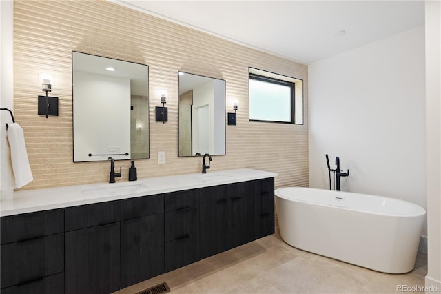 2625 W 23rd Ave, Denver, CO 80211 - full bathroom with double vanity, decorative backsplash, a freestanding tub, and a sink