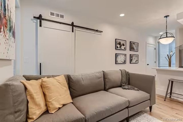 2625 W 23rd Ave, Denver, CO 80211 - living area with recessed lighting, a barn door, visible vents, and light wood-style floors