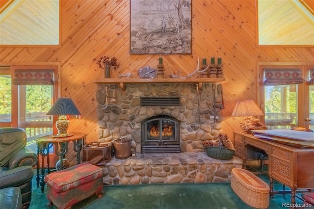 carpeted living room with wood walls, plenty of natural light, and a towering ceiling