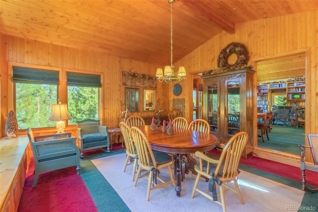 dining area featuring wood ceiling, carpet floors, beamed ceiling, wooden walls, and an inviting chandelier