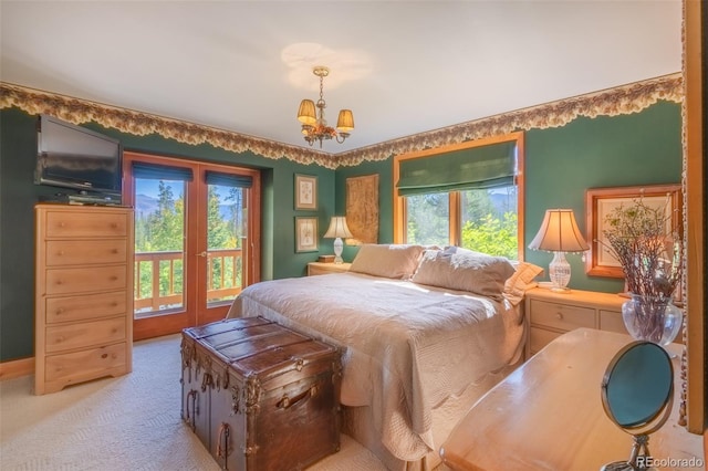 bedroom with a chandelier and light colored carpet