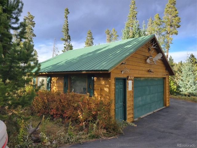 exterior space with an outbuilding and a garage