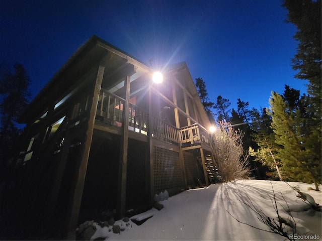 view of snow covered exterior with a deck