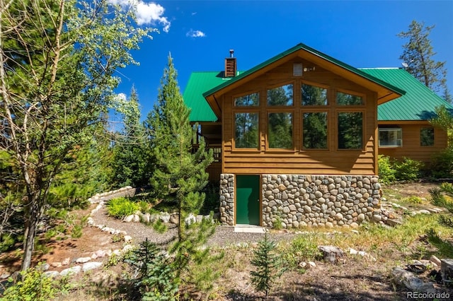 460 Gcr 466, Grand Lake, CO 80447 - back of property featuring a chimney, metal roof, and stone siding