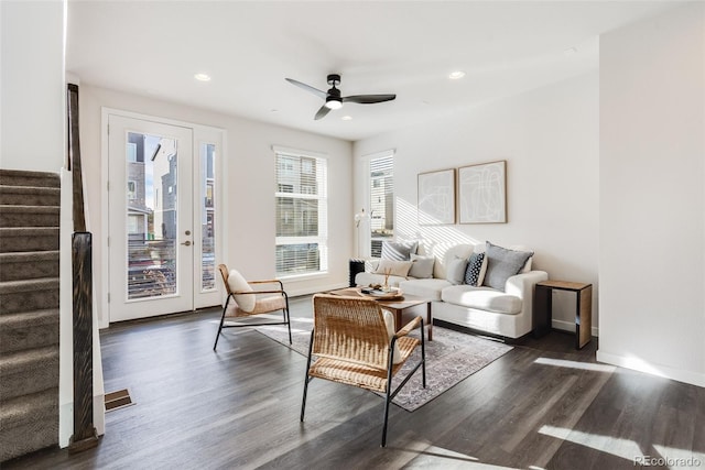 living room with dark wood-type flooring and ceiling fan