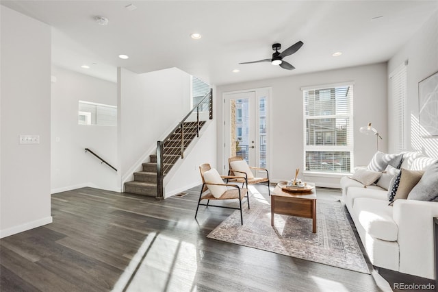 living room with ceiling fan and dark hardwood / wood-style flooring