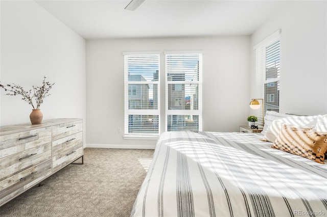 carpeted bedroom featuring multiple windows