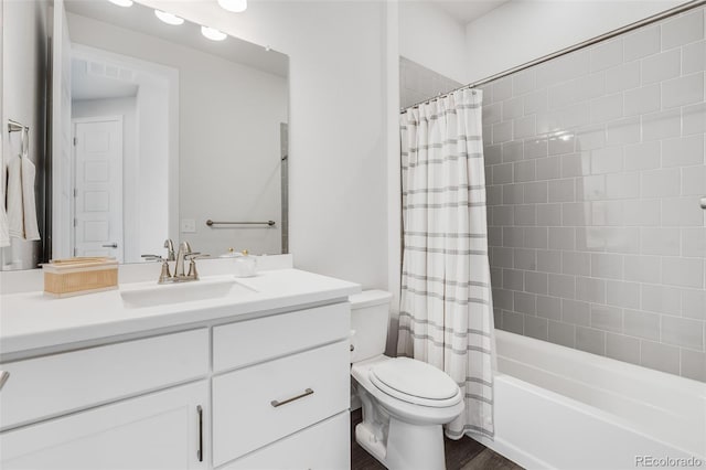 full bathroom featuring hardwood / wood-style flooring, shower / bath combo, vanity, and toilet