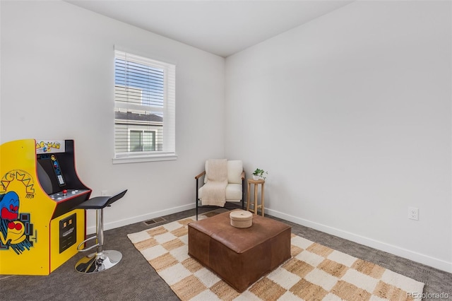 living area with dark colored carpet