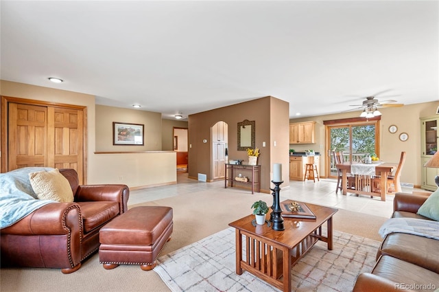 living room with ceiling fan and light carpet