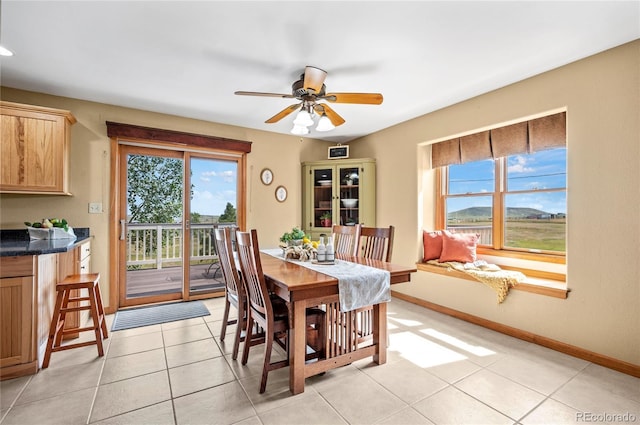 tiled dining room with ceiling fan