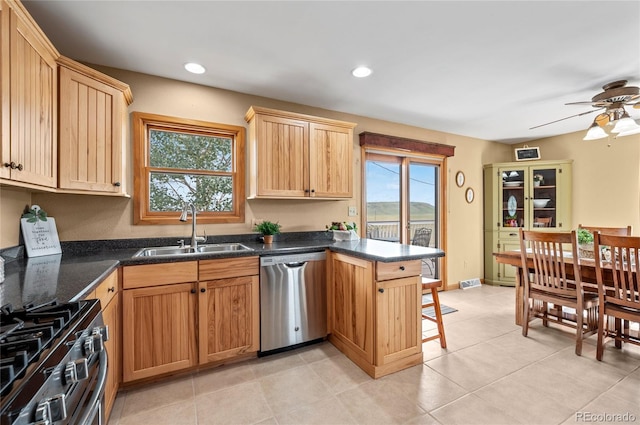 kitchen featuring sink, ceiling fan, light tile patterned floors, and stainless steel appliances