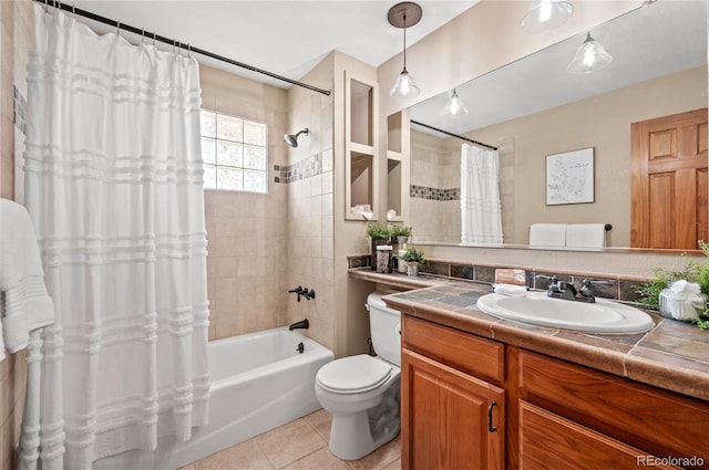 full bathroom featuring tile patterned floors, shower / bath combination with curtain, vanity, and toilet