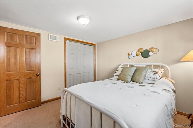 carpeted bedroom featuring a closet