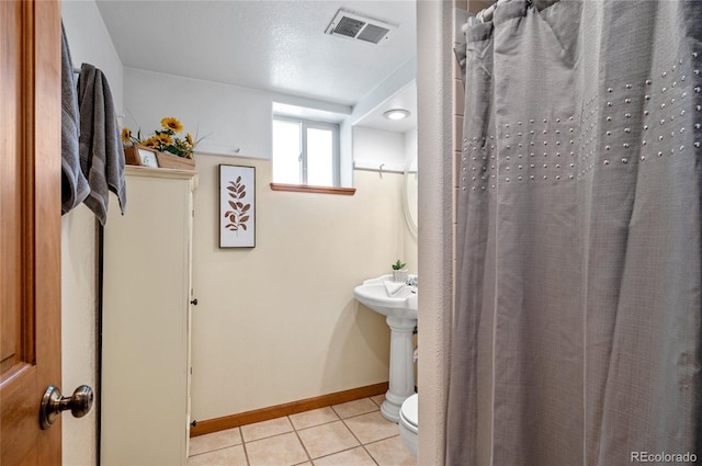 bathroom with tile patterned flooring and toilet