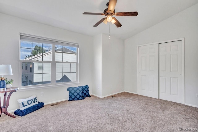 interior space featuring carpet floors, a closet, ceiling fan, and lofted ceiling