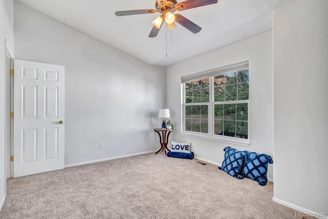 interior space with ceiling fan and carpet