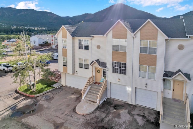 view of front of home featuring a mountain view and a garage