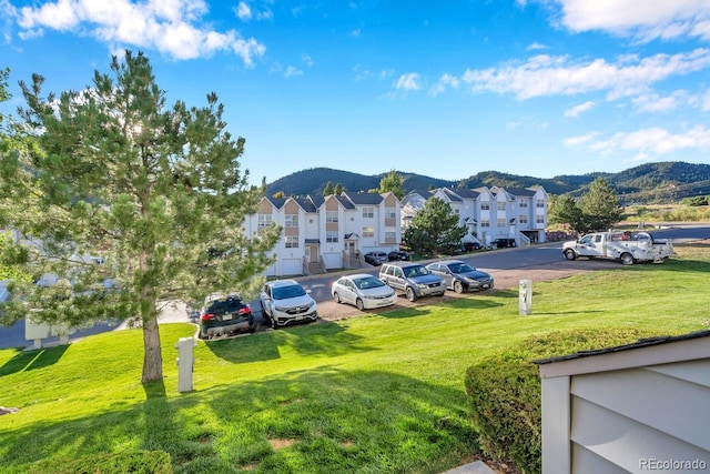 exterior space with a lawn and a mountain view