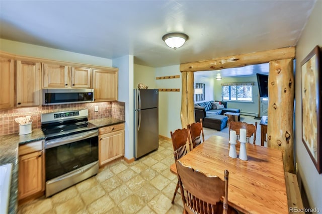 kitchen with stainless steel appliances, a baseboard heating unit, light brown cabinetry, and backsplash