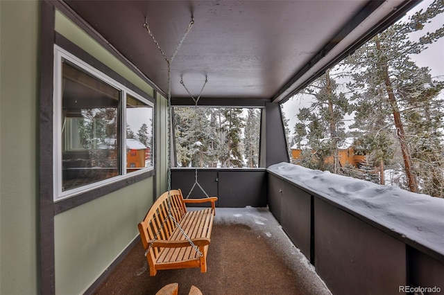 view of snow covered back of property