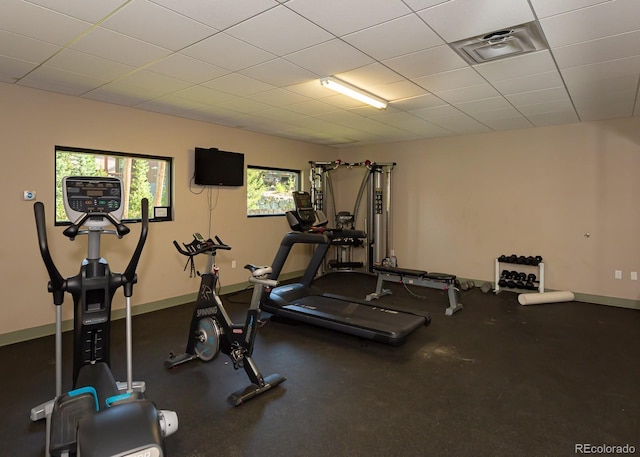 gym featuring a paneled ceiling