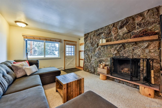 living room featuring a baseboard radiator, a fireplace, and light carpet