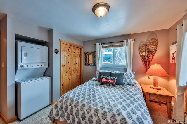 bedroom with stacked washer and dryer and a closet