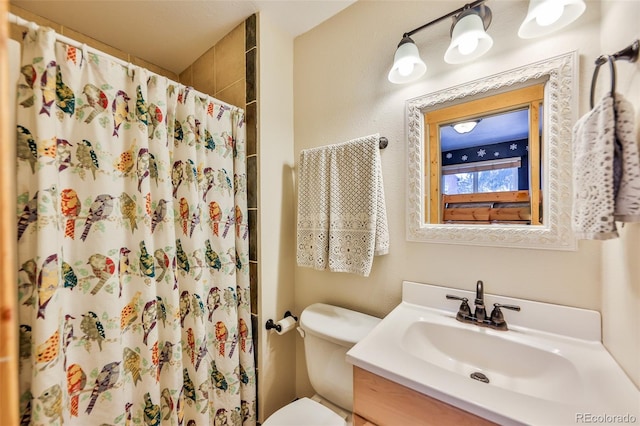 bathroom with a shower with curtain, vanity, and toilet