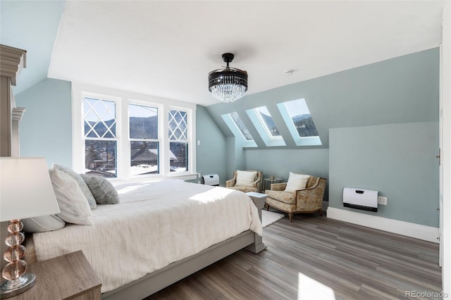 bedroom with wood-type flooring and lofted ceiling with skylight