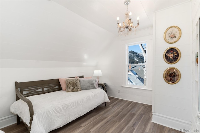 bedroom featuring dark wood-type flooring and a chandelier